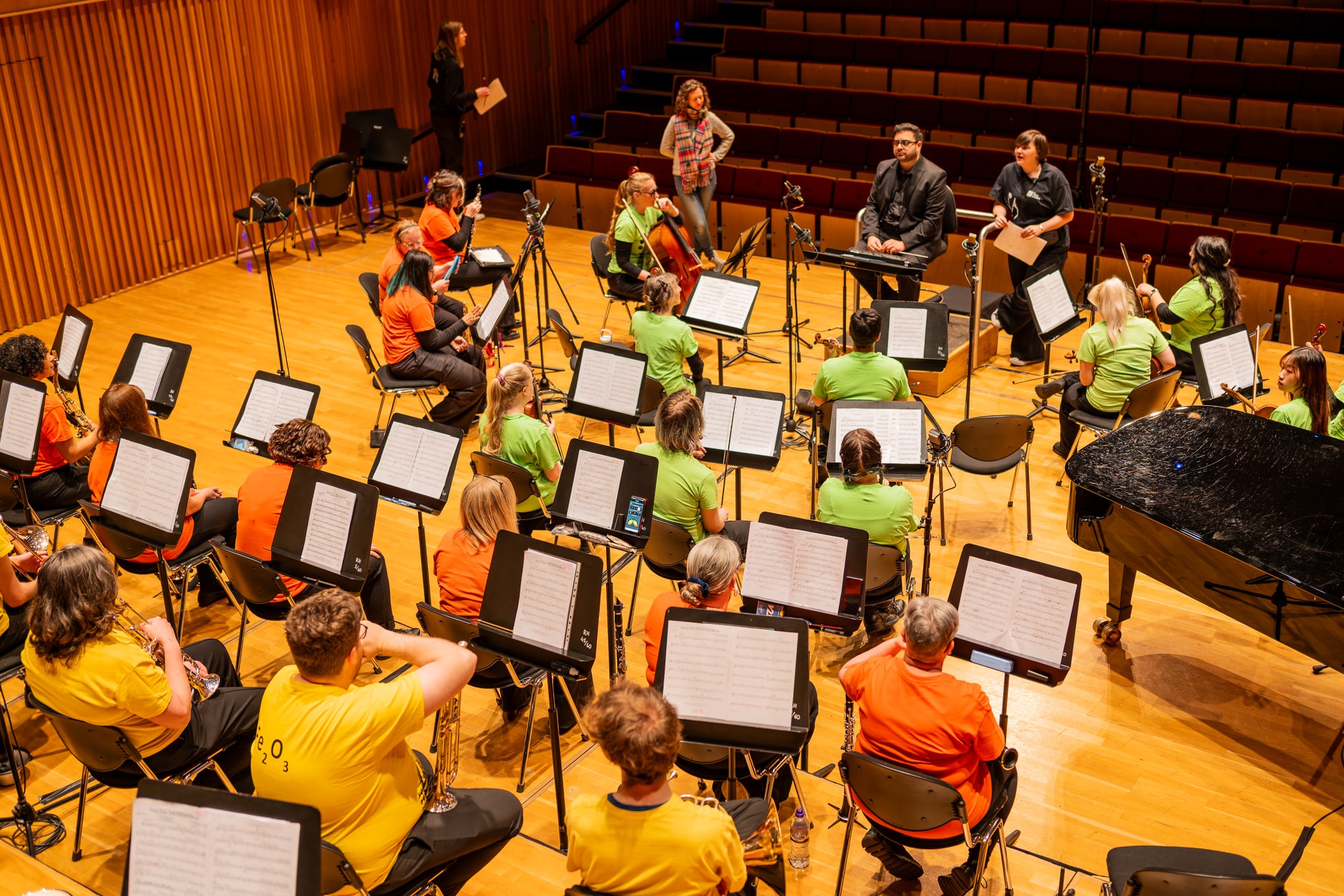 Orchestra staff giving the orchestra information about the day