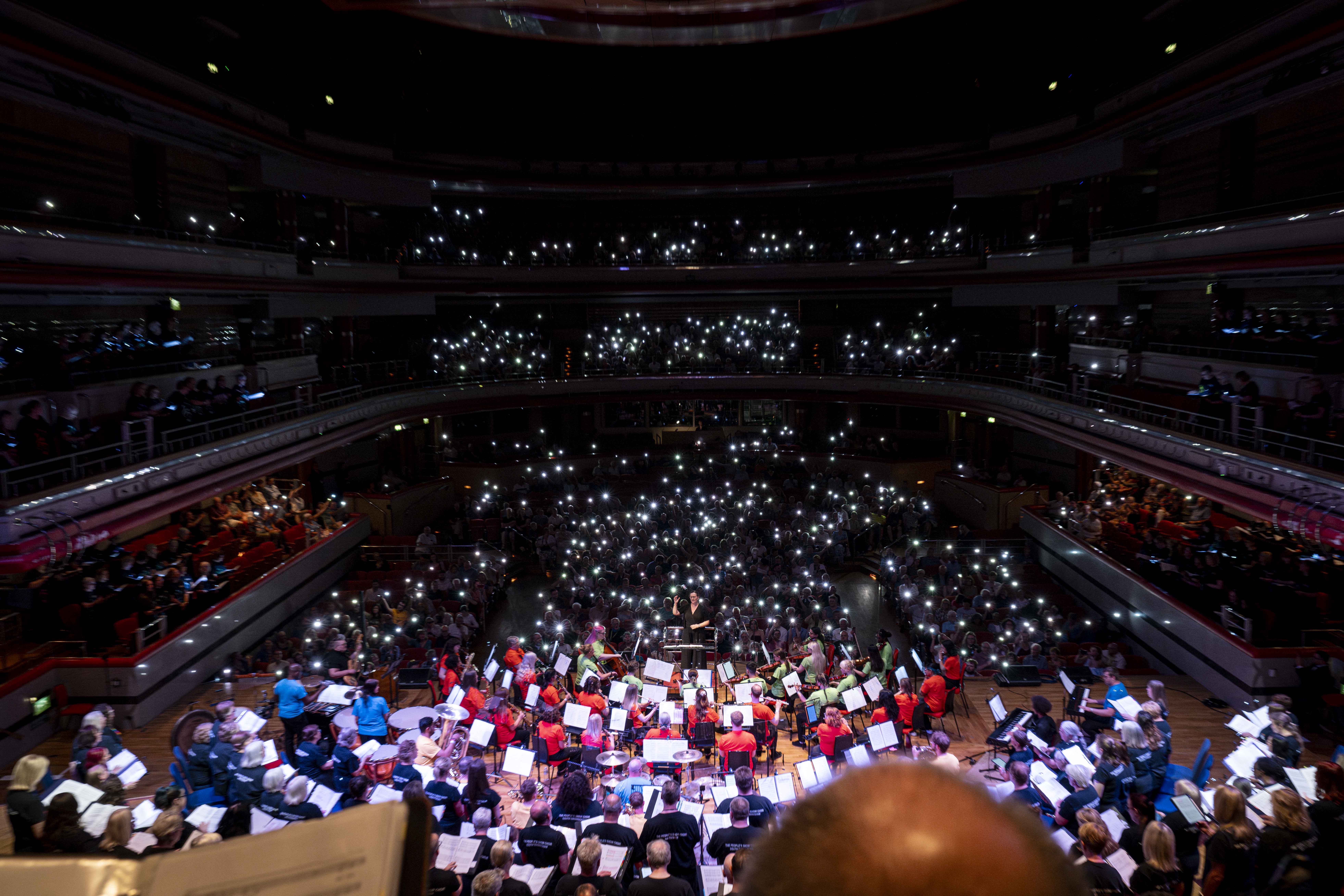 POV image: Audience shining their lights in the darkness