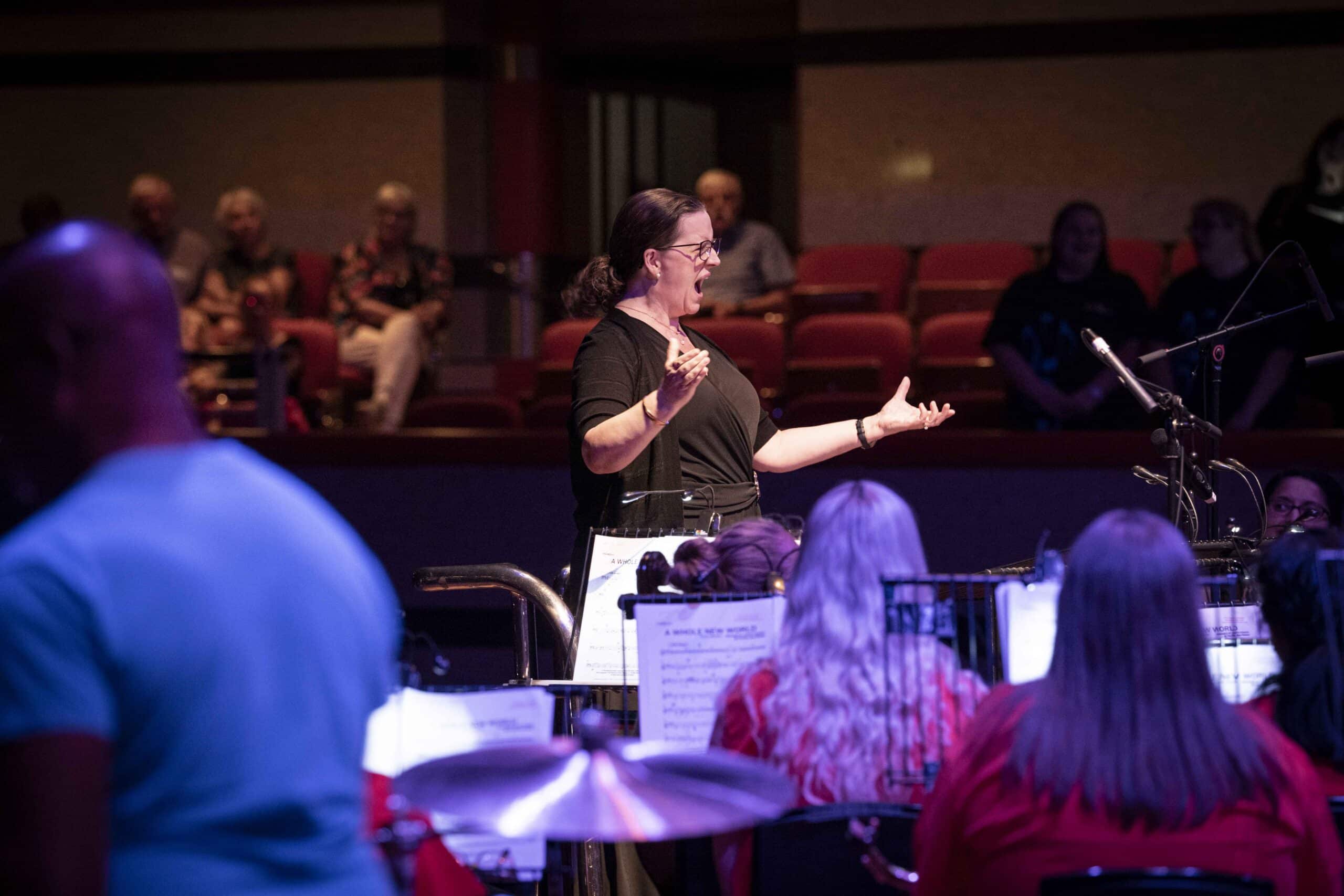 Conductor performing on stage.