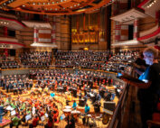 The People's Orchestra and The People's Show Choir rehearsing together inside Birmingham Symphony Hall.